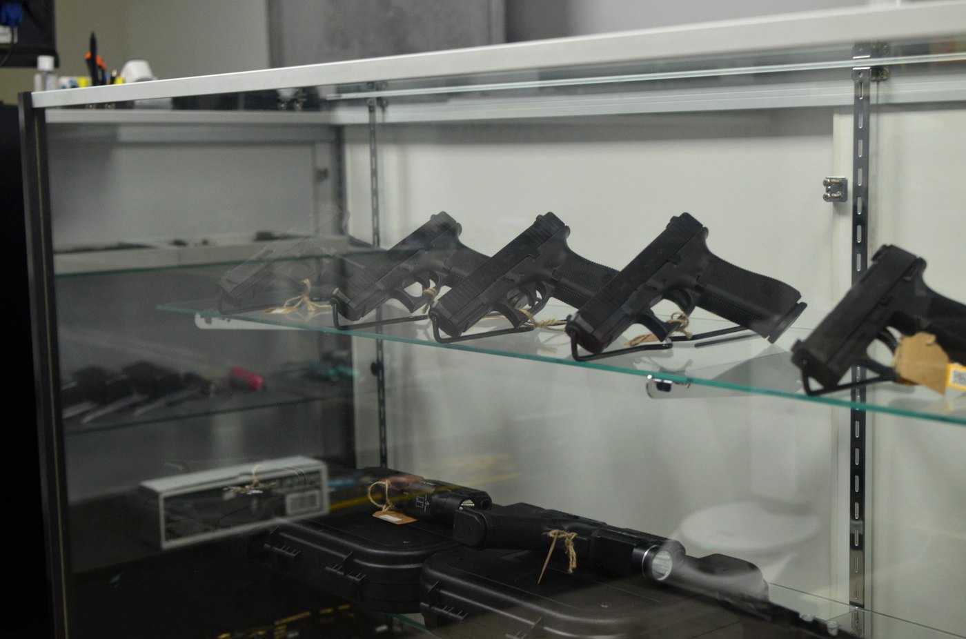 Handguns displayed inside a glass case at Glen Cove Armory.
